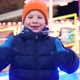 Boy with milk tooth gap is very happy at the Christmas market - VideoHive Item for Sale