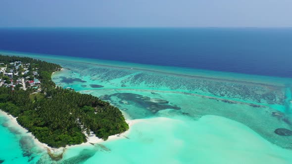 Beautiful fly over travel shot of a sandy white paradise beach and turquoise sea background in colou