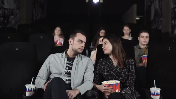 Positive Couple Are Eating Popcorn and Discussing a Movie