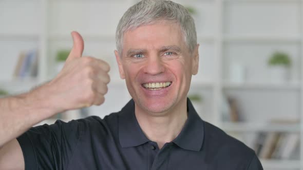 Successful Middle Aged Businessman Showing Thumbs Up