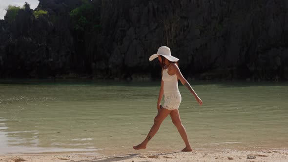 Young Woman In Sun Hat Walking In Tidewater