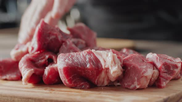 Putting Pieces of Raw Meat on Cutting Board