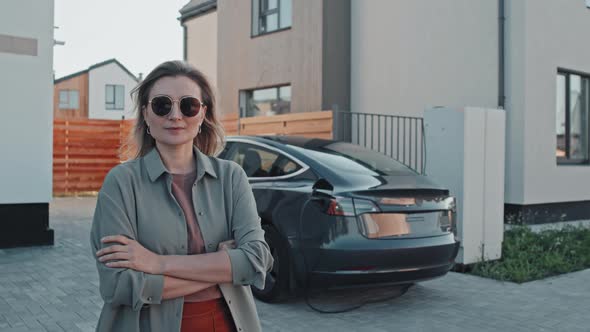 Portrait of Woman with Electric Car