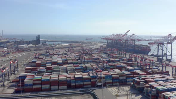 Cargo containers in busy port, aerial. Drone shot. 