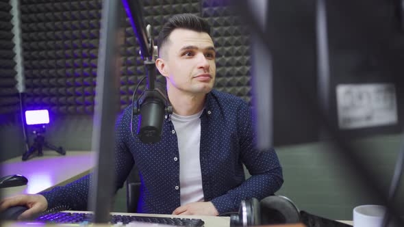 a Radio Host Conducts a Live Broadcast in a Professional Radio Studio