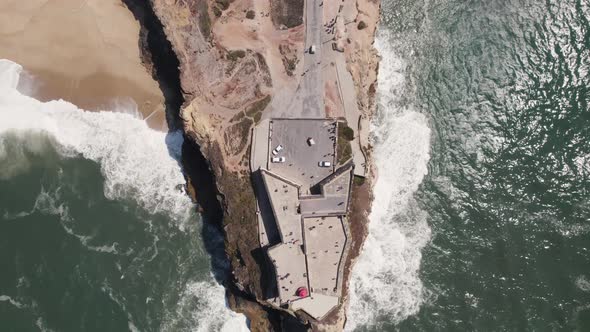 Aerial top down reverse over Nazaré or Nazare lighthouse, Portugal