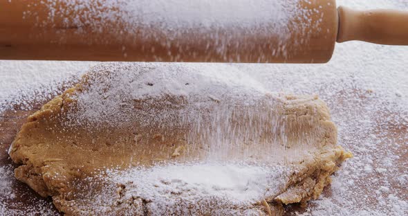 Flattened dough on a wooden table 4k