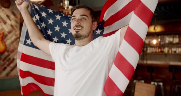 Man with the Flag of the National Country of USA Watching Sport Game