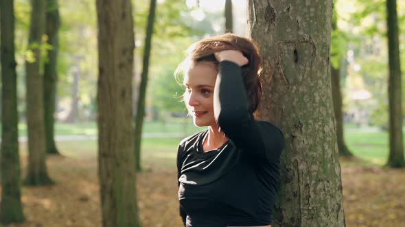Cheerful Woman Relaxing at Park During Workout