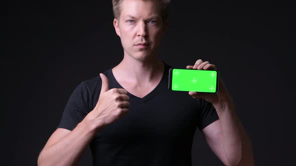 Young Handsome Man Using Mobile Phone with Green Screen Chroma Key