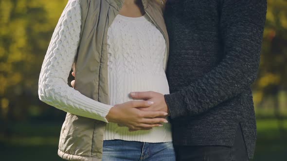 Pregnant Woman With Husband Stroking Belly, Prenatal Care, Fertility Science