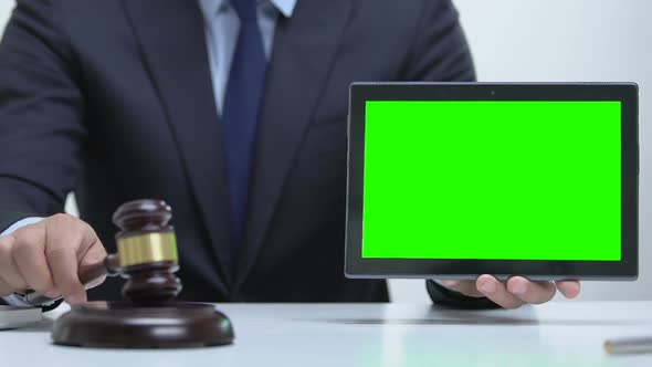 Male Holding Tablet With Green Screen, Hitting Gavel on Block, Cybercrime