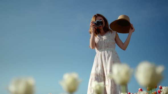 Happy Woman Taking Photos in Flower Garden