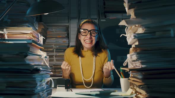 Cheerful woman celebrating in the office