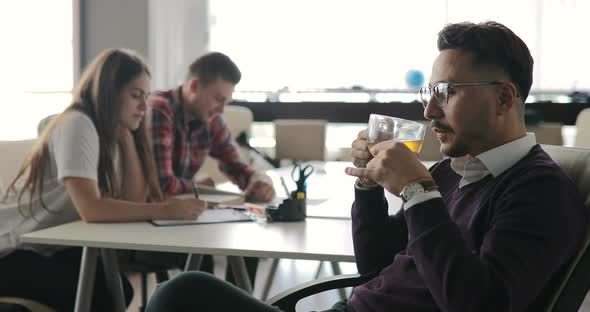 Boss is Talking to Employees at a Meeting