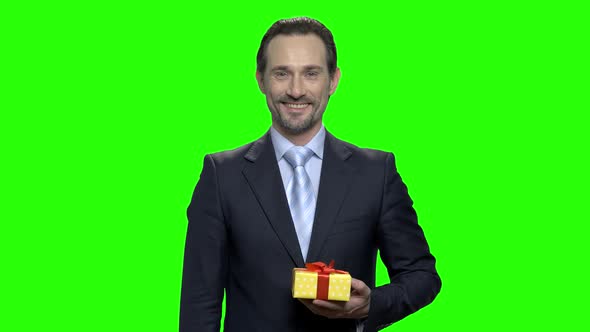 Portrait of Smiling Cheerful Man Giving You a Present