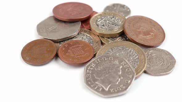 UK Currency pounds coins rotating close up footage against the white background