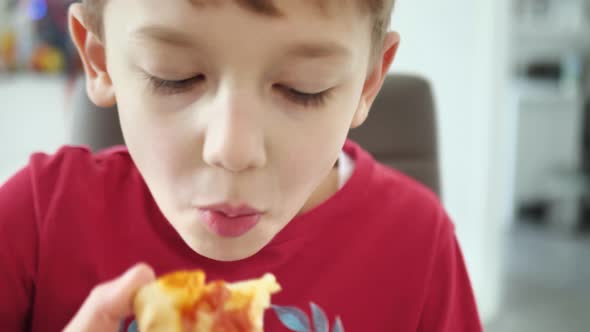 Close Up of a Boy Eating Pizza