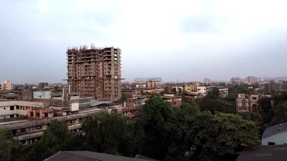 Drone flying towards under construction building in India