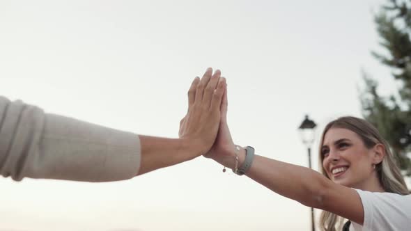 Couple Touching Palms, Arms Raised Together, Close-up On Hands