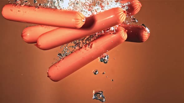 The Sausages Slowly Fall Into the Water with Air Bubbles