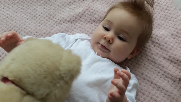 Adorable Baby Playing with Teddy Bear