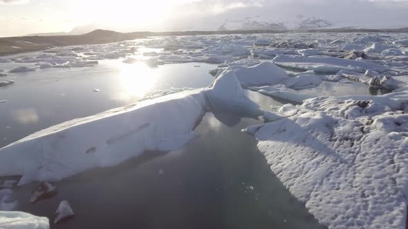 Aerial view of Jokulsarlon glacier lagoon with iceberg floating and mountains