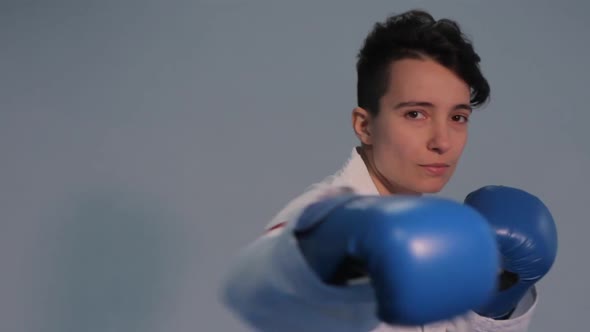 Woman Taekwondo Fighter Trains Shadow Boxing Punches and Kicks