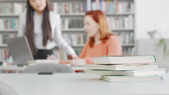 Selective Focus on Books Female Students Studying on Background