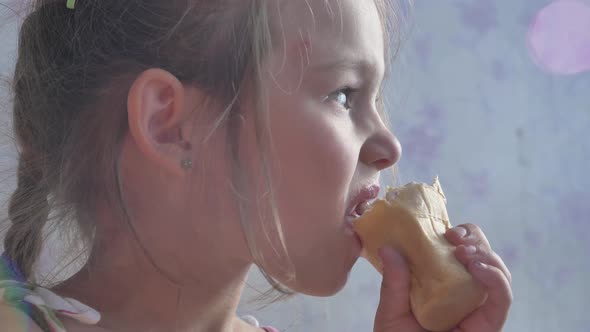 Small Girl Eats Icecream in Waffle Glass and Bites