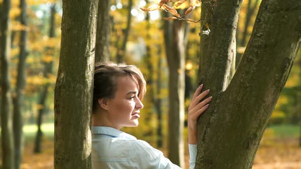 Beautiful female dreaming in the autumn park