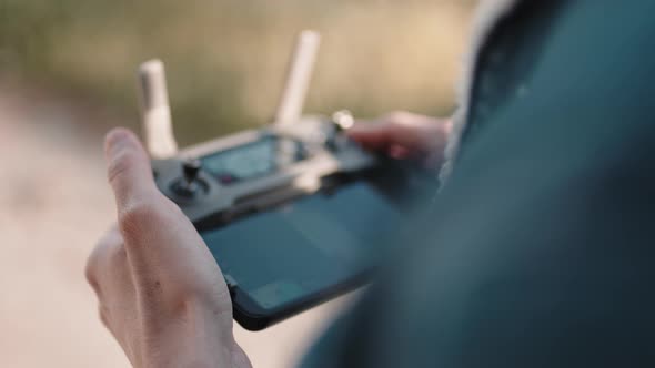 Hand of a Drone Operator Man While Pilot a Quadcopter Remote Controller