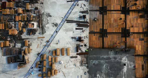 Flight Over the Construction Site of the Shopping Center, with Crane and Scaffolding. with People at