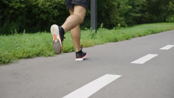 Legs of Runner on Road with Marking