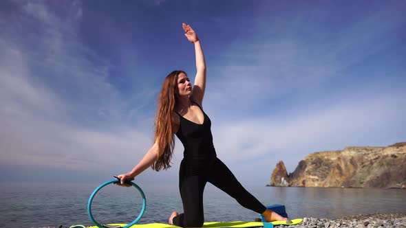 Young Woman with Long Hair Fitness Instructor in Black Sportswear Leggings and Tops Stretching on a