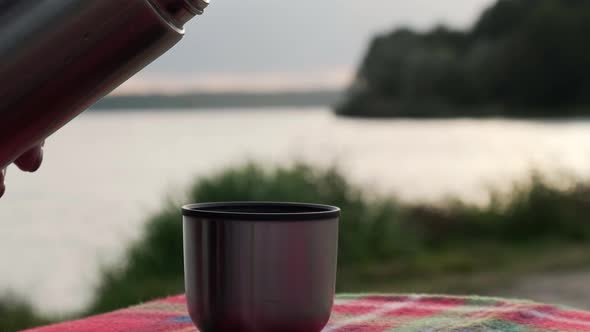 Hot Tea Pouring From Thermo Cup Outdoors in Autumn Park