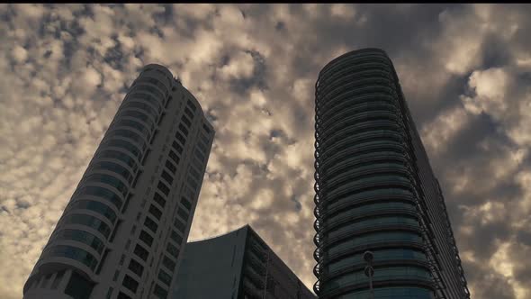 Timelapse of Clouds behind Skyscraper