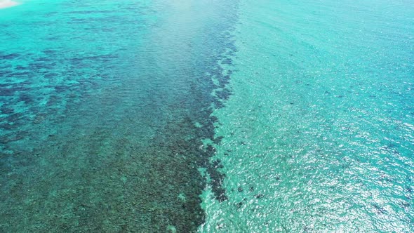 Aerial drone shot panorama of idyllic sea view beach journey by blue water and clean sand background