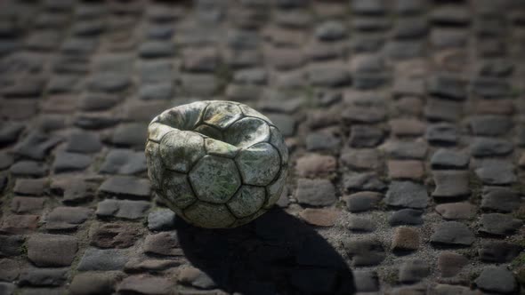 Old Soccer Ball in the Pavement Yard