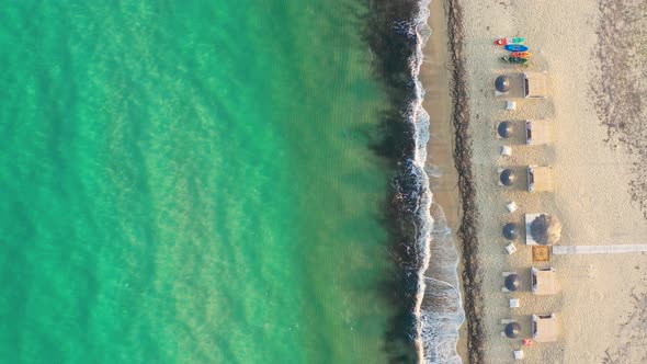 Top view Sandy coastline with white turquiose sea waves