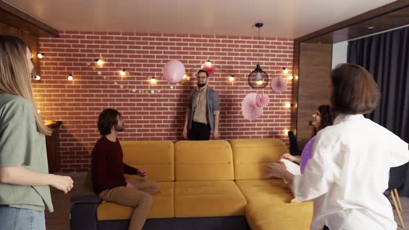 Group of People at Living Room Playing with Balloon Have Fun