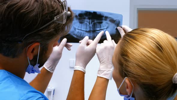 Dentists having discussion on x-ray