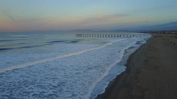 Aerial drone uav view of a pier, beach and ocean.