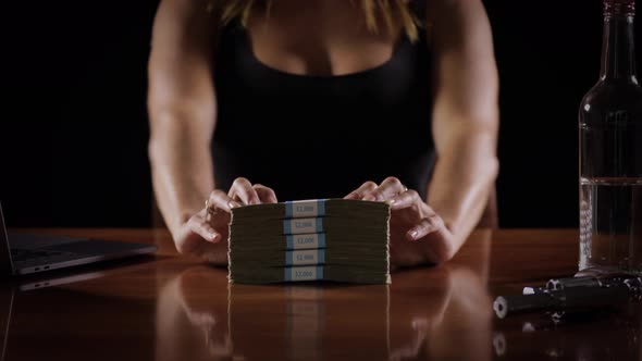 Sexy woman with a stack of money