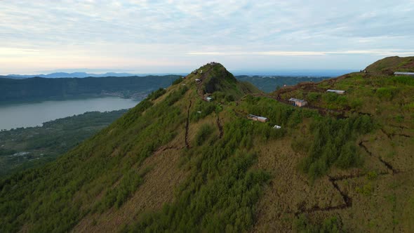 trekking paths leading to the ridge at Mount Batur volcano crater in Bali Indonesia during sunrise