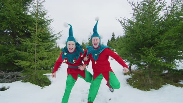 Two happy elves jumping together