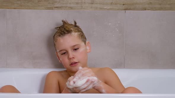 Boy Playing in Bathroom Child Bathe and Inflates Soap Bubbles