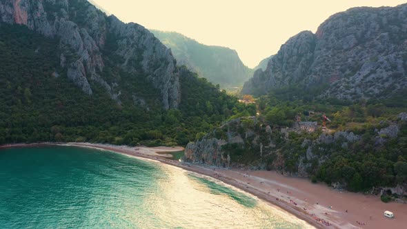 Tropical Beach with Rocky Mountains and Clear Sea Water