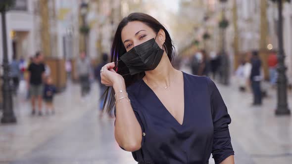 Happy Mature Woman Taking Off Medical Mask