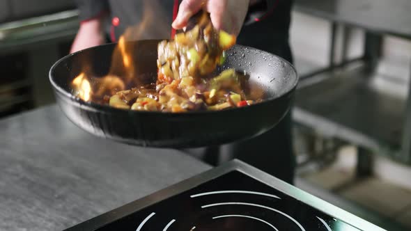 Chef Cooking Vegetable in Frying Pan on Burning Fire Slow Motion